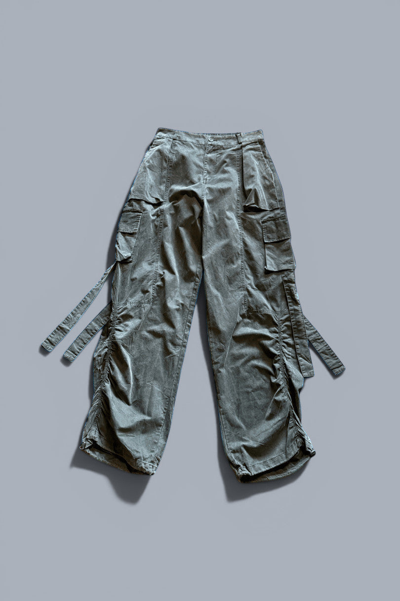 METTLE TWEED Peepal wide-leg cargo pants in dark grey with oversized flap pockets and dangling straps.