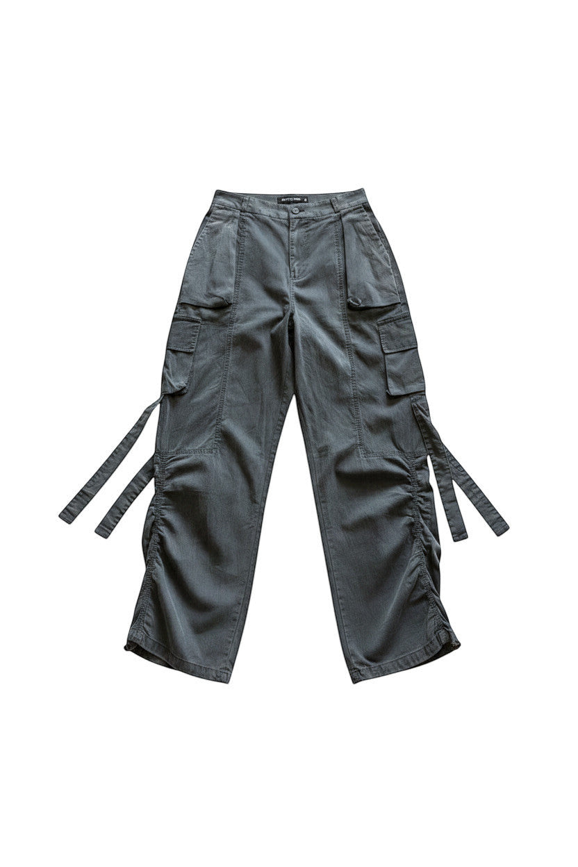METTLE TWEED Peepal wide-leg cargo pants in dark grey with oversized flap pockets and dangling straps.