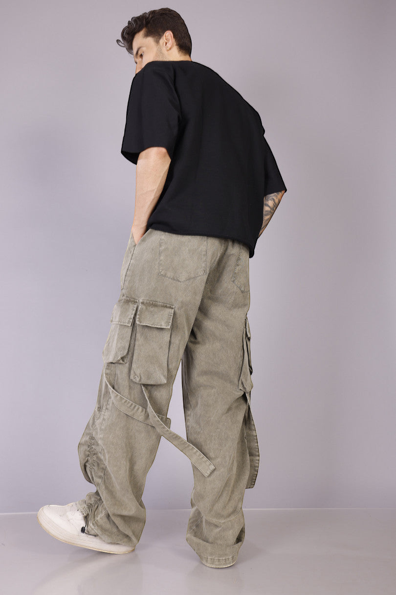 METTLE TWEED Peepal wide-leg cargo pants in washed khaki with oversized flap pockets and dangling straps.
