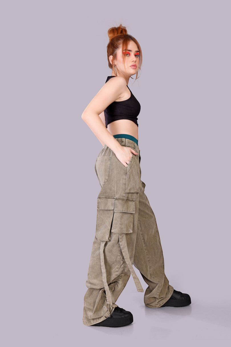 METTLE TWEED Peepal wide-leg cargo pants in washed khaki with oversized flap pockets and dangling straps.
