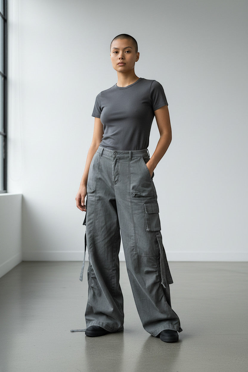 METTLE TWEED Peepal grey wide-leg cargo pants with oversized pockets and dangling straps.